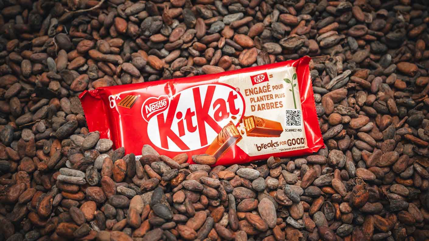A KitKat bar leans on a pile of certified cocoa beans. A KitKat bar leans on a pile of certified cocoa beans.