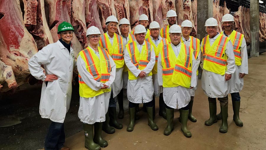 A group of people stand in a Cargill beef processing plant. A group of people stand in a Cargill beef processing plant.