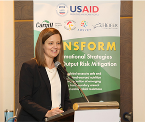 A woman stands at a podium to give an update on the TRANSFORM program.