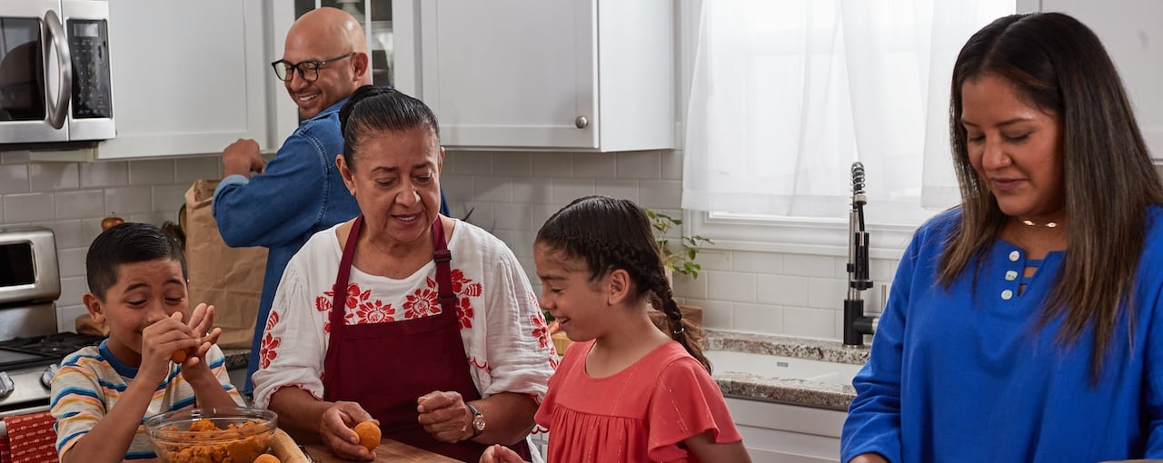 Family preparing empanadas together in the kitchen. Family preparing empanadas together in the kitchen.