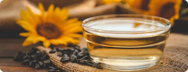 Sunflower oil, seeds and flower on dark wooden background. Sunflower oil, seeds and flower on dark wooden background.