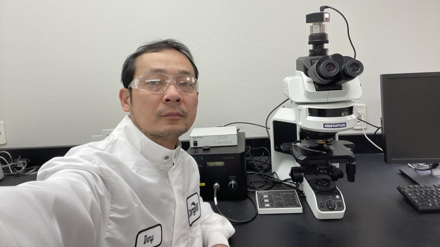 A Cargill crop innovation scientist sits in front of a light microscope. A Cargill crop innovation scientist sits in front of a light microscope.