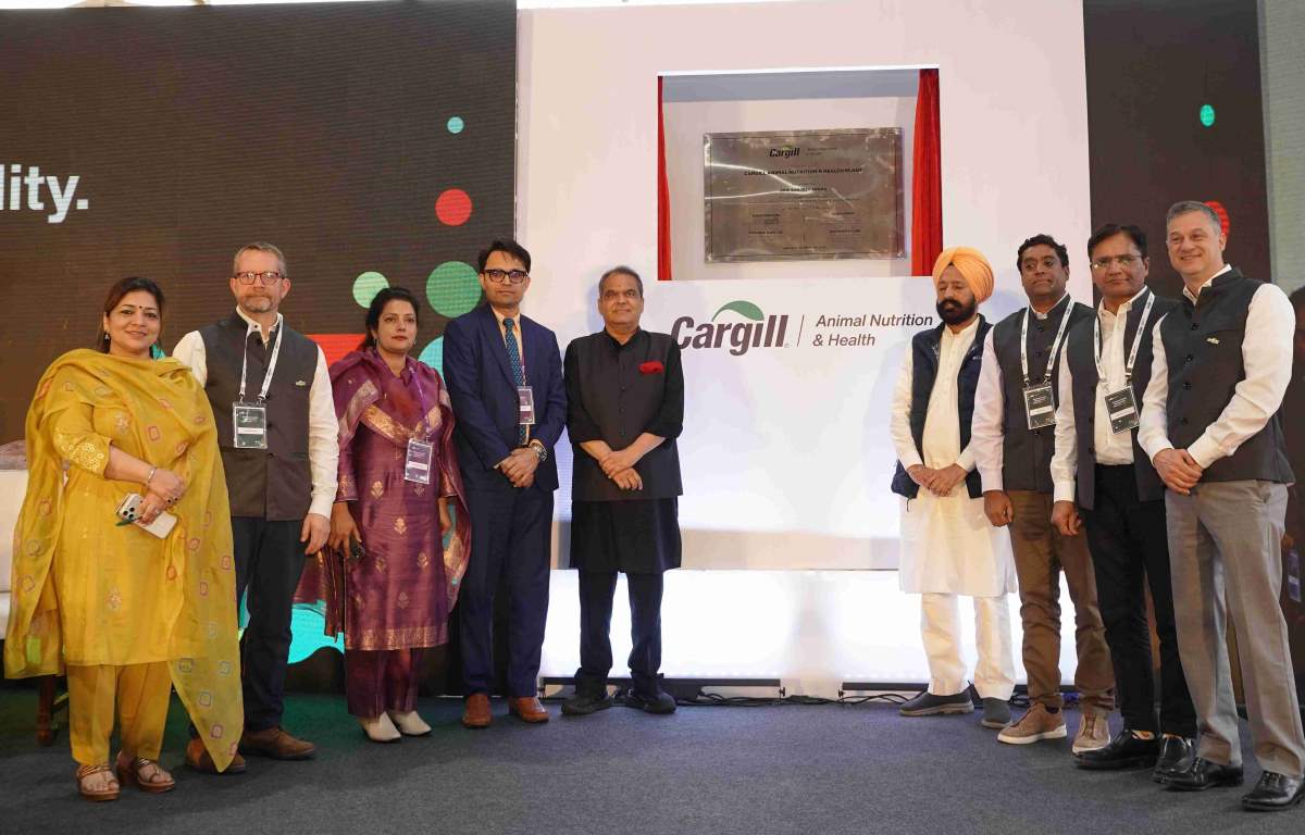 Cargill Animal Nutrition & Health leaders and Punjab officials stand on stage at the inauguration of the Wazirabad dairy feed plant, posing in front of a commemorative plaque.