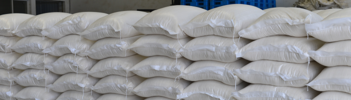 Stacked white sacks in warehouse