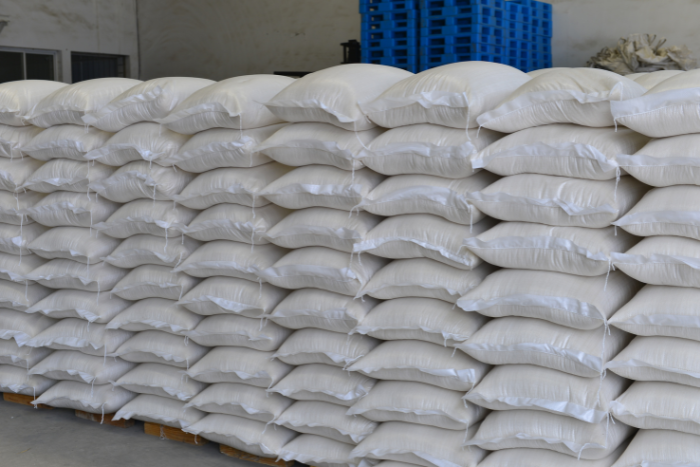 Stacked white sacks in warehouse