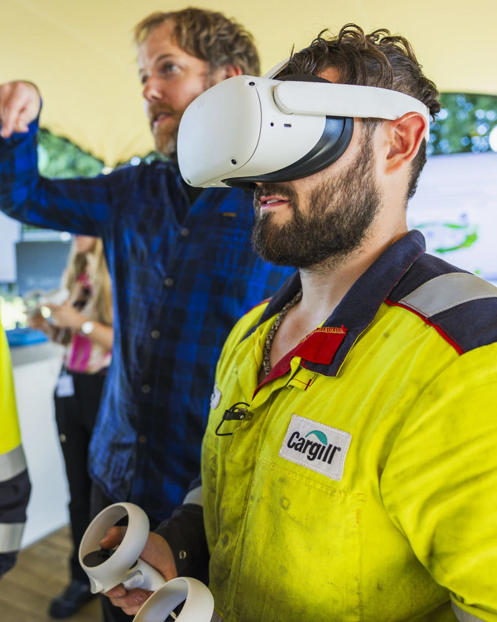 Employee using a virtual reality headset and controllers during training.