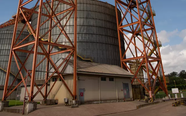 Photo of a grain storage silo, highlighting the large metal structures of the grain elevators