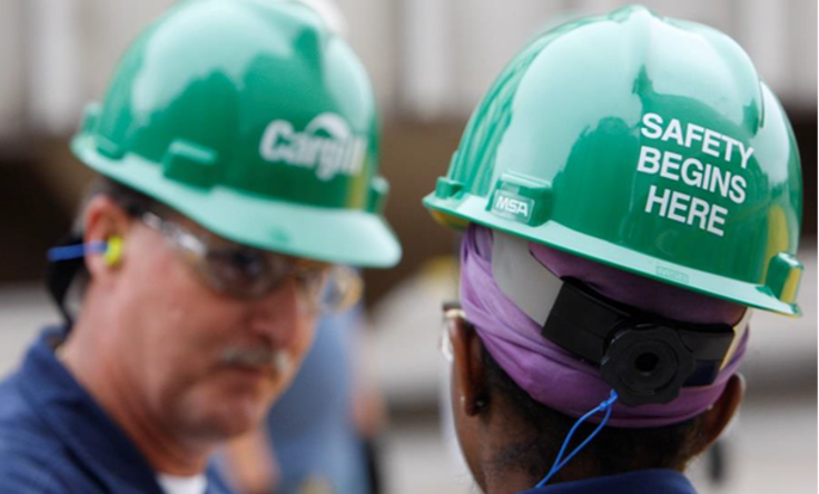 2 men in Cargill hard hats with "Safety Begins Here"